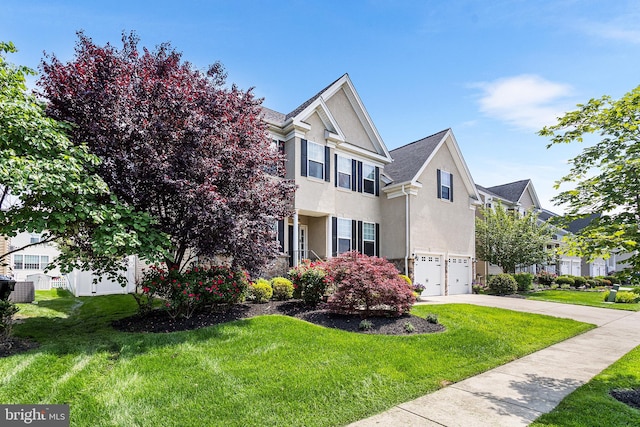 318 Windsor Rd, Mullica Hill, NJ 08062 - view of front facade with an attached garage, stucco siding, concrete driveway, and a front lawn