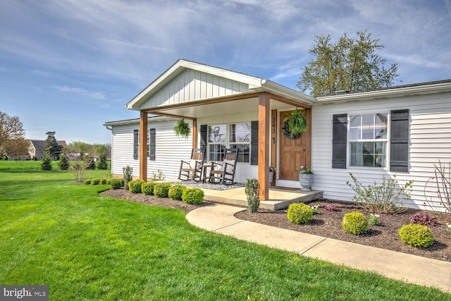 343 N Locust St, Myerstown, PA 17067 - view of front of house featuring a front yard, a porch, and board and batten siding