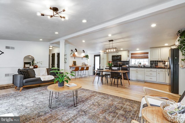 343 N Locust St, Myerstown, PA 17067 - living area with light wood-style floors, a chandelier, beamed ceiling, and recessed lighting