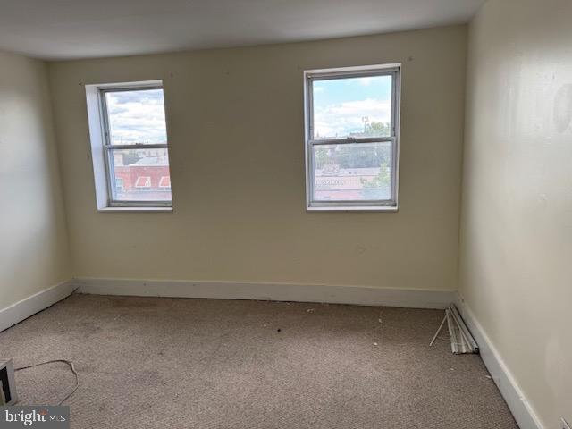 1232 S 11th St, Philadelphia, PA 19147 - empty room featuring carpet flooring and baseboards