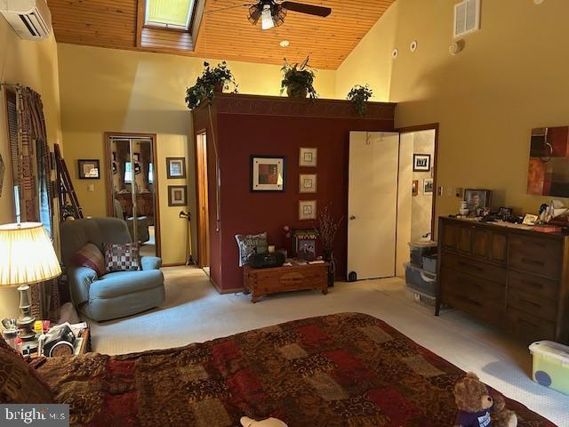 1469 Cathys Ln, North Wales, PA 19454 - carpeted living area with high vaulted ceiling, a ceiling fan, an AC wall unit, and wooden ceiling