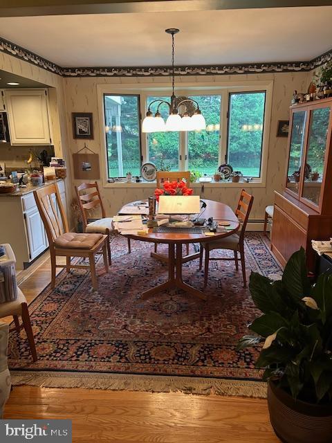 1469 Cathys Ln, North Wales, PA 19454 - dining area with a chandelier, light wood-style floors, and healthy amount of natural light