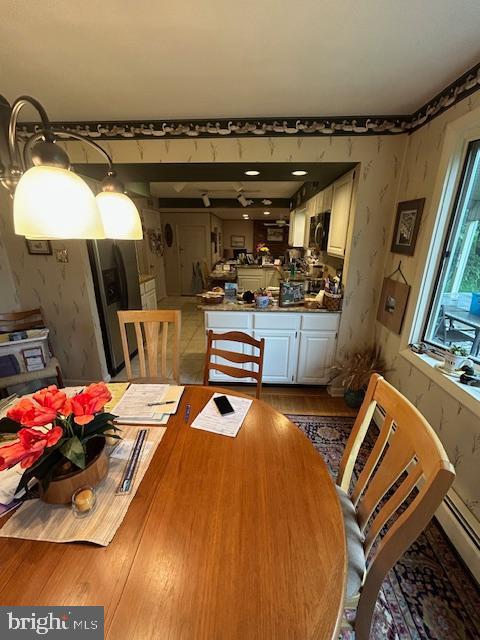 1469 Cathys Ln, North Wales, PA 19454 - dining area with wallpapered walls, wood finished floors, and a baseboard heating unit