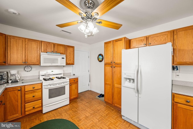 1541 Foresman Dr Unit 125, Pottstown, PA 19464 - kitchen with white appliances, a ceiling fan, brown cabinetry, and light countertops