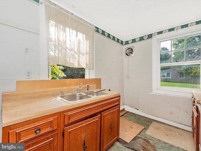 23419 Spire St, Clarksburg, MD 20871 - kitchen featuring a sink, brown cabinetry, and light countertops