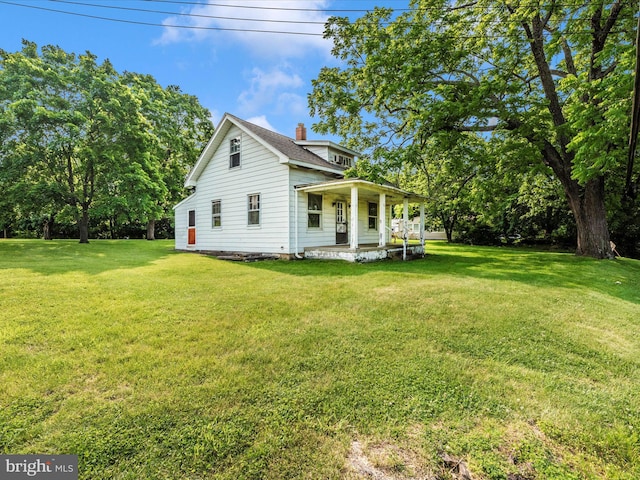 23419 Spire St, Clarksburg, MD 20871 - view of property exterior with a porch, a lawn, and a chimney