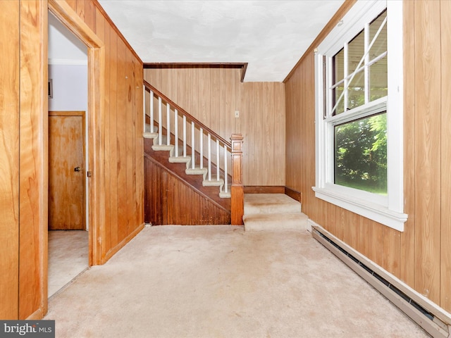 23419 Spire St, Clarksburg, MD 20871 - stairway featuring a baseboard radiator, wood walls, carpet flooring, and baseboards