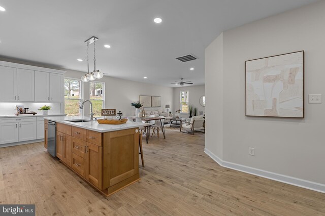 6978 Bray Rd, Hayes, VA 23072 - kitchen with a sink, white cabinets, light countertops, recessed lighting, and light wood finished floors