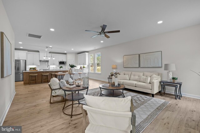6978 Bray Rd, Hayes, VA 23072 - living area with light wood-type flooring, baseboards, ceiling fan, and recessed lighting