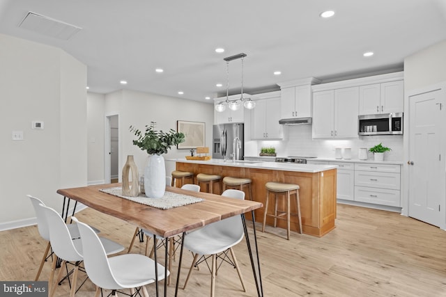 6978 Bray Rd, Hayes, VA 23072 - dining space with light wood finished floors, recessed lighting, and baseboards