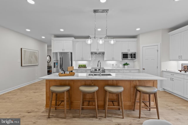 6978 Bray Rd, Hayes, VA 23072 - kitchen featuring appliances with stainless steel finishes, a sink, backsplash, light countertops, and white cabinetry
