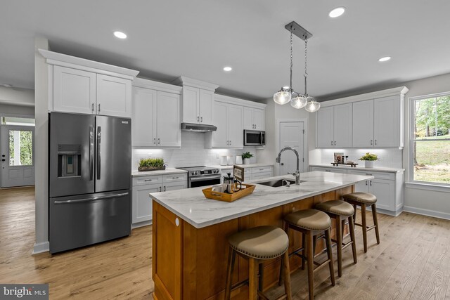6978 Bray Rd, Hayes, VA 23072 - kitchen featuring stainless steel appliances, a sink, white cabinetry, backsplash, and recessed lighting