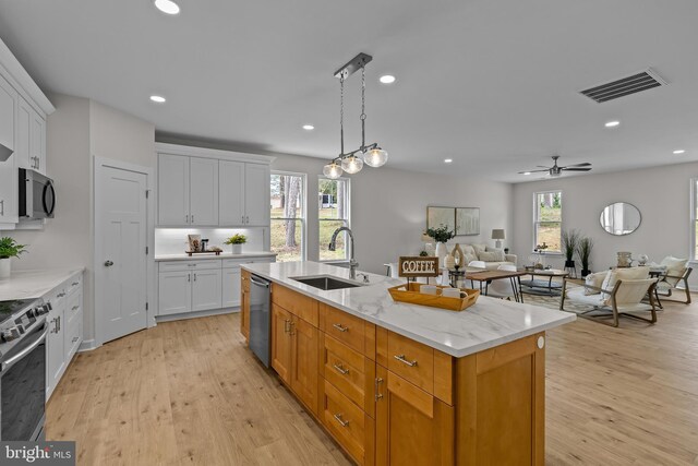 6978 Bray Rd, Hayes, VA 23072 - kitchen with a sink, appliances with stainless steel finishes, white cabinetry, light wood-style floors, and recessed lighting