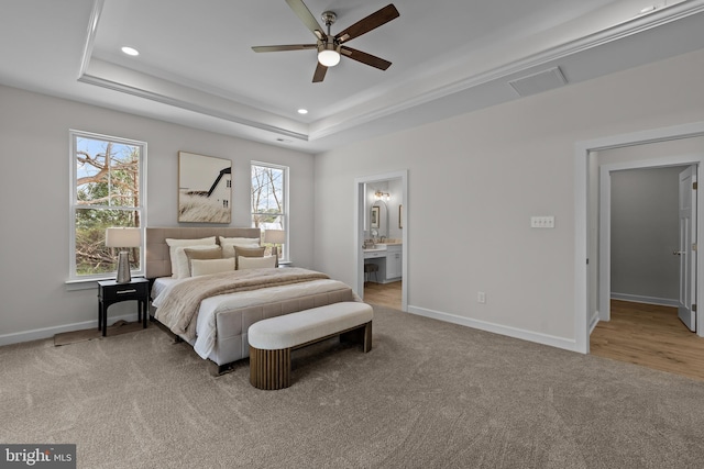 6978 Bray Rd, Hayes, VA 23072 - carpeted bedroom featuring a raised ceiling, baseboards, recessed lighting, connected bathroom, and a ceiling fan