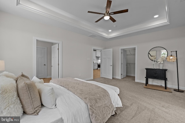 6978 Bray Rd, Hayes, VA 23072 - bedroom featuring a tray ceiling, a walk in closet, recessed lighting, light colored carpet, and baseboards