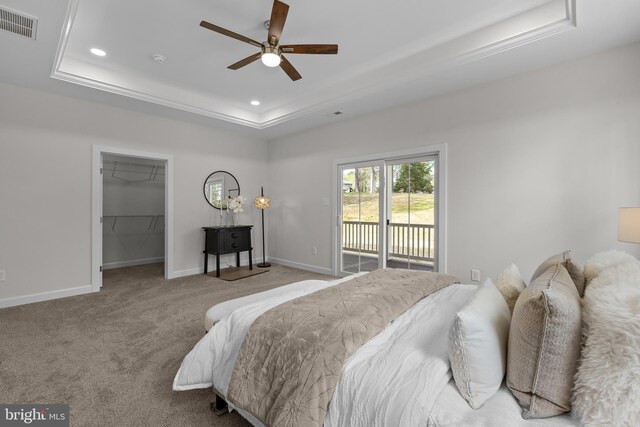 6978 Bray Rd, Hayes, VA 23072 - carpeted bedroom featuring a raised ceiling, access to outside, baseboards, recessed lighting, and a walk in closet