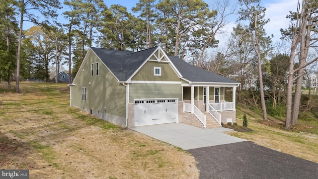 6978 Bray Rd, Hayes, VA 23072 - view of front of home featuring a porch, driveway, roof with shingles, brick siding, and a front yard