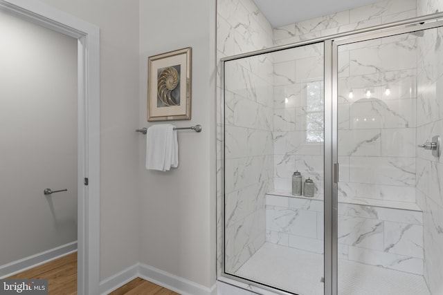 6978 Bray Rd, Hayes, VA 23072 - bathroom with a marble finish shower, wood finished floors, and baseboards