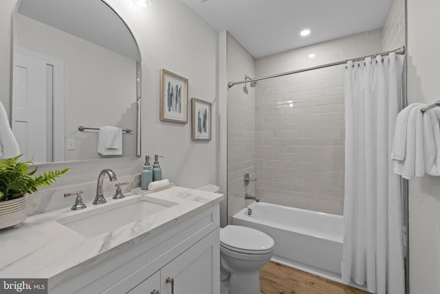 6978 Bray Rd, Hayes, VA 23072 - full bath with vanity, toilet, shower / bath combo, wood finished floors, and recessed lighting