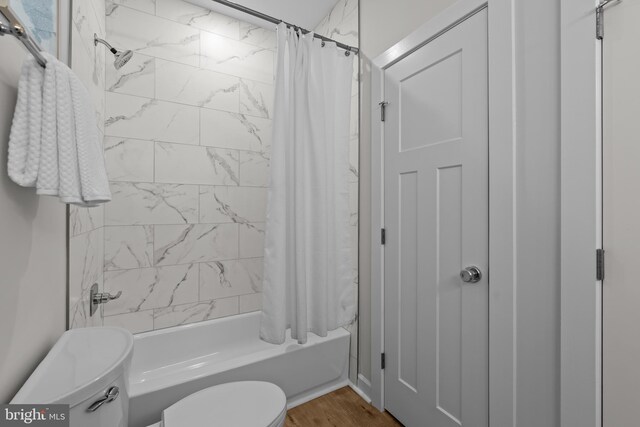 6978 Bray Rd, Hayes, VA 23072 - full bathroom featuring toilet, shower / bath combo, and wood finished floors