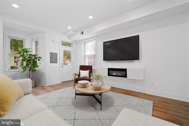 1615 5th St NW, Washington, DC 20001 - living room with electric panel, light wood finished floors, a glass covered fireplace, recessed lighting, and baseboards
