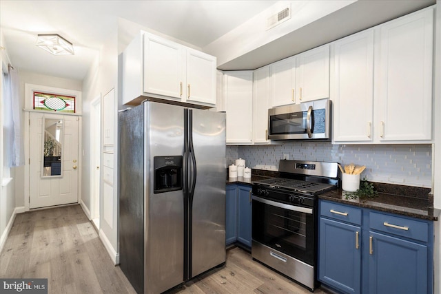 57 E Heath St, Baltimore, MD 21230 - kitchen with stainless steel appliances, blue cabinetry, light wood-style floors, and white cabinetry