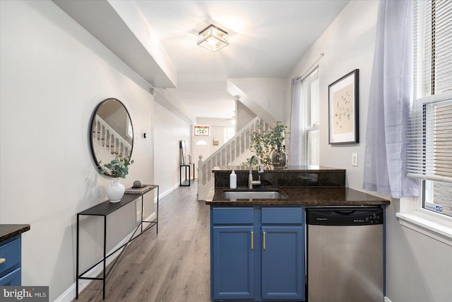 57 E Heath St, Baltimore, MD 21230 - kitchen featuring dishwasher, a sink, blue cabinets, light wood-type flooring, and dark stone countertops