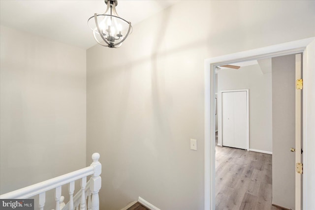 57 E Heath St, Baltimore, MD 21230 - corridor with an upstairs landing, light wood-style floors, a chandelier, and baseboards