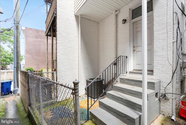 57 E Heath St, Baltimore, MD 21230 - doorway to property featuring brick siding and central air condition unit