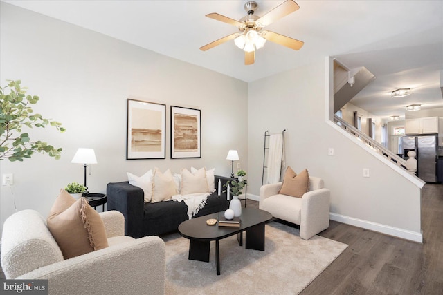 57 E Heath St, Baltimore, MD 21230 - living room with wood finished floors, a ceiling fan, baseboards, and stairway