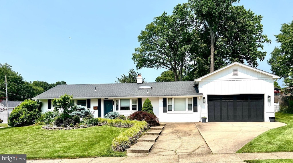 5214 Juliet St, Springfield, VA 22151 - ranch-style home with an attached garage, a front yard, concrete driveway, and a chimney