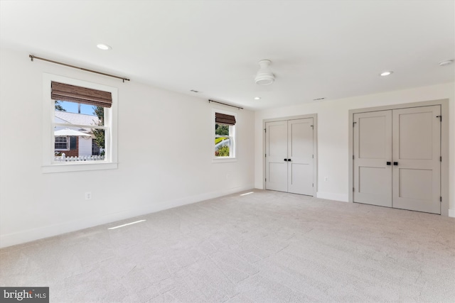 5214 Juliet St, Springfield, VA 22151 - unfurnished bedroom featuring multiple windows, light carpet, two closets, and recessed lighting