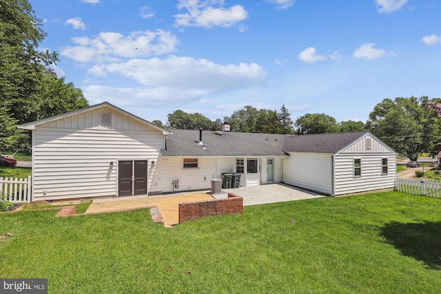 5214 Juliet St, Springfield, VA 22151 - back of house featuring a patio area, board and batten siding, roof with shingles, and a chimney