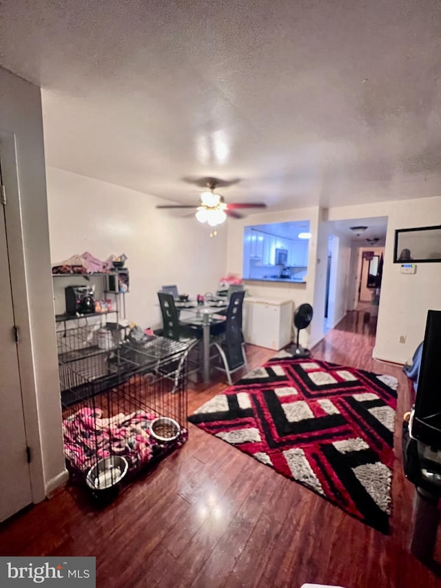 2634 Bowen Rd SE Unit 101, Washington, DC 20020 - living area featuring wood finished floors, ceiling fan, and a textured ceiling