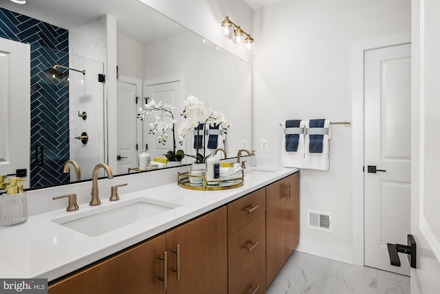 HOMESITE85 Crown St, Baltimore, MD 21230 - bathroom with double vanity, marble look tiles, tiled shower, and baseboards