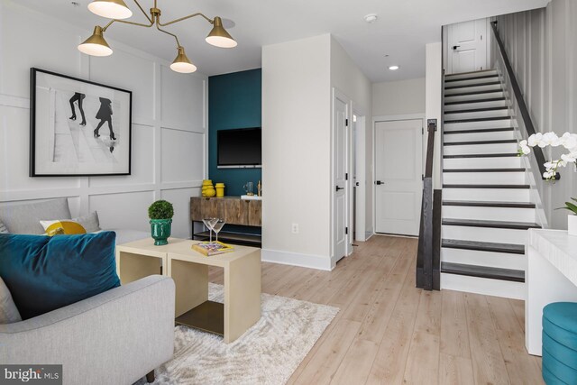 HOMESITE85 Crown St, Baltimore, MD 21230 - living room with stairway, light wood-style floors, baseboards, recessed lighting, and a decorative wall