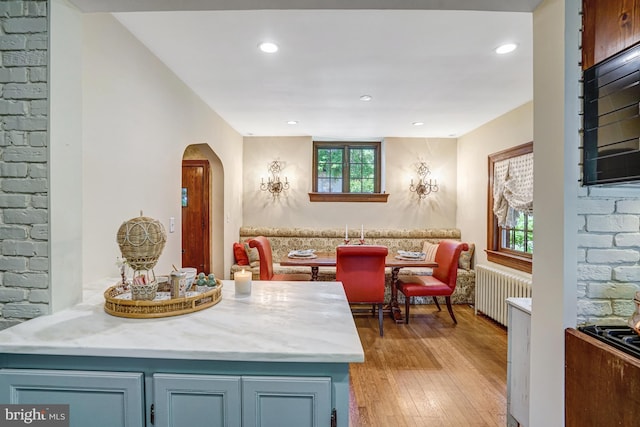 2305 S Inge St S, Arlington, VA 22202 - kitchen featuring radiator heating unit, arched walkways, light wood-style floors, open floor plan, and recessed lighting