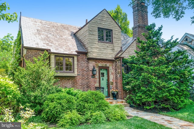2305 S Inge St S, Arlington, VA 22202 - tudor house with a high end roof, a chimney, and brick siding