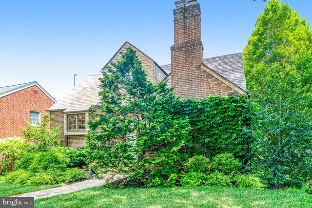 2305 S Inge St S, Arlington, VA 22202 - view of side of property featuring a chimney, a high end roof, and brick siding