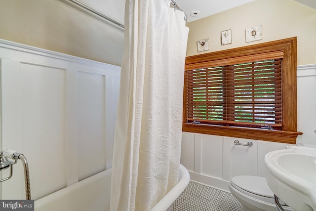 2305 S Inge St S, Arlington, VA 22202 - full bathroom with a decorative wall, wainscoting, toilet, shower / bath combination with curtain, and tile patterned floors