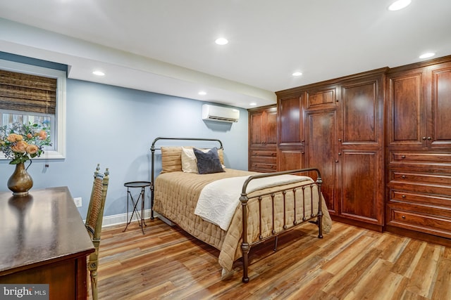 2305 S Inge St S, Arlington, VA 22202 - bedroom with a wall mounted air conditioner, recessed lighting, light wood-type flooring, and baseboards