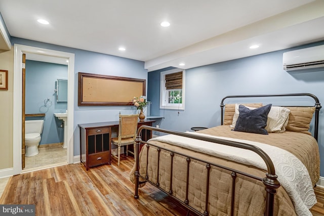 2305 S Inge St S, Arlington, VA 22202 - bedroom with a wall unit AC, recessed lighting, light wood-style floors, ensuite bathroom, and baseboards
