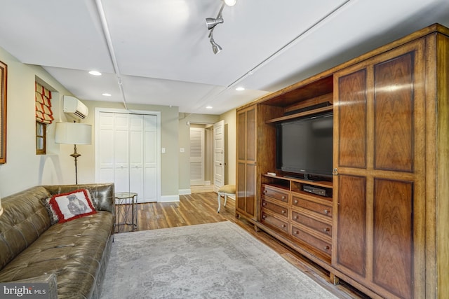 2305 S Inge St S, Arlington, VA 22202 - living room featuring an AC wall unit, recessed lighting, wood finished floors, and baseboards