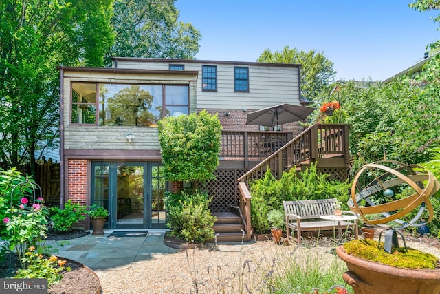 2305 S Inge St S, Arlington, VA 22202 - back of property with a deck, brick siding, and stairway