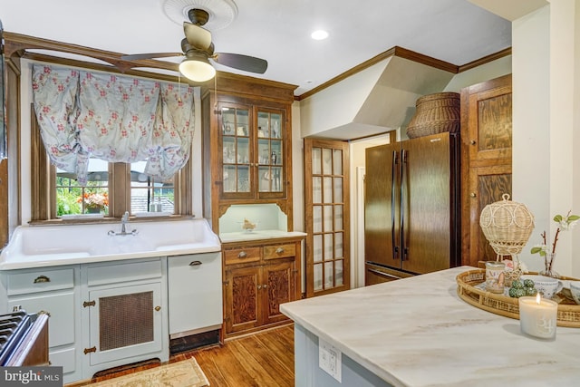 2305 S Inge St S, Arlington, VA 22202 - kitchen with refrigerator, ornamental molding, light wood-style flooring, light countertops, and a ceiling fan