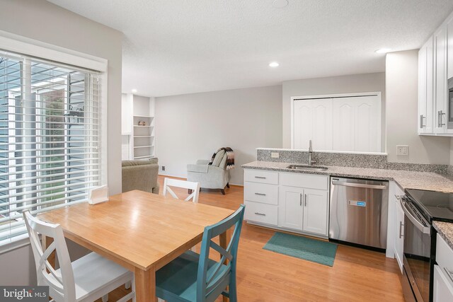 261 E Juniper Ave, Sterling, VA 20164 - kitchen with appliances with stainless steel finishes, a sink, plenty of natural light, light wood finished floors, and recessed lighting