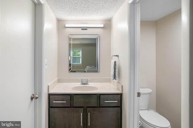 261 E Juniper Ave, Sterling, VA 20164 - bathroom with vanity, toilet, and a textured ceiling