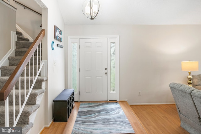 261 E Juniper Ave, Sterling, VA 20164 - foyer entrance with wood finished floors, stairs, baseboards, and a chandelier