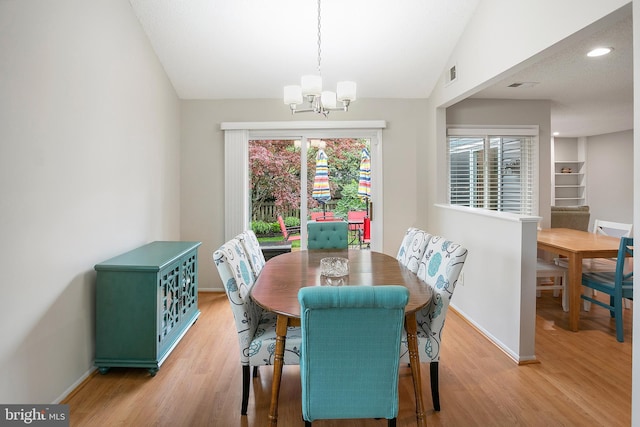 261 E Juniper Ave, Sterling, VA 20164 - dining area with a chandelier, light wood-style floors, baseboards, and vaulted ceiling