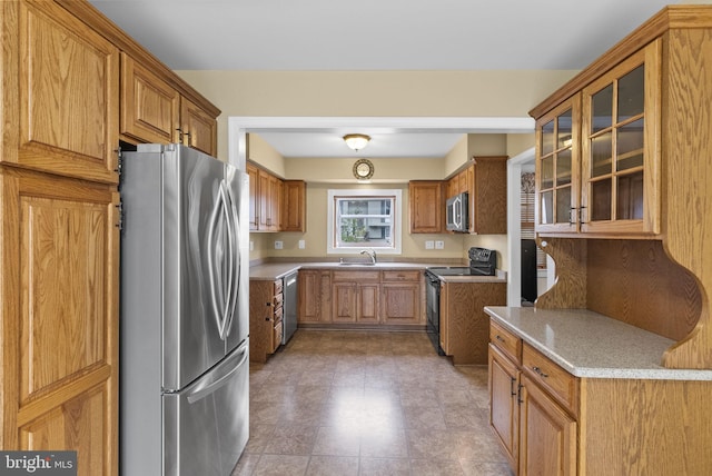 2034 Beach Blvd, Point Pleasant Boro, NJ 08742 - kitchen with stainless steel appliances, a sink, brown cabinets, and glass insert cabinets